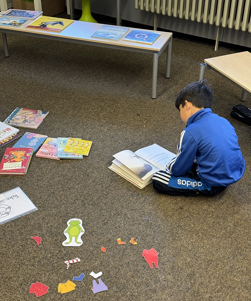 Ein Schüler liest ein Bilderbuch